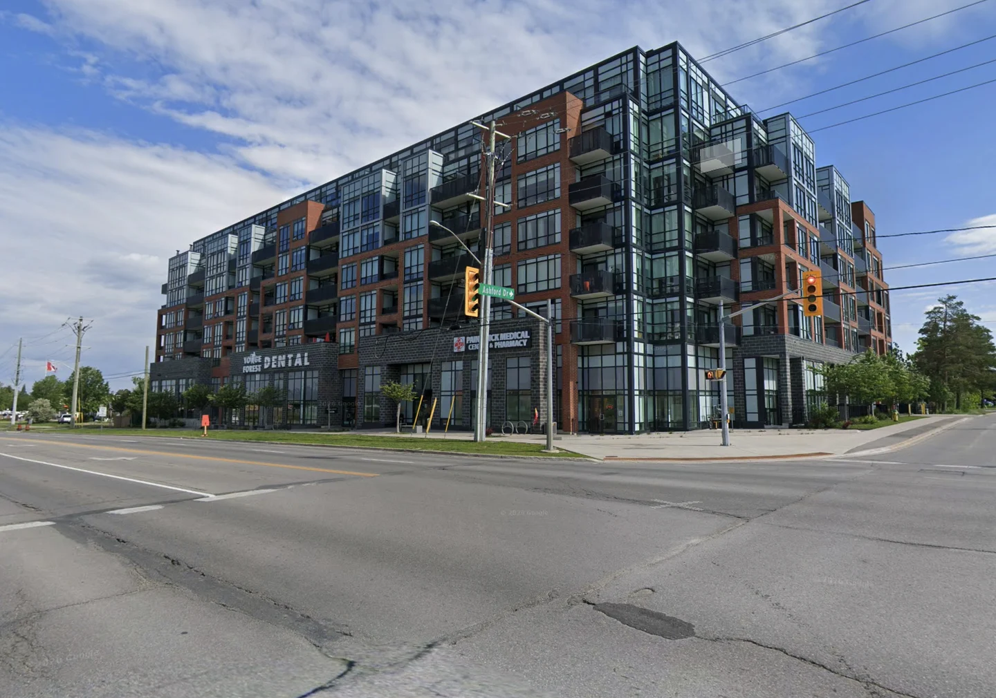Multi-storey residential building with a dental office, medical centre and pharmacy at street level.